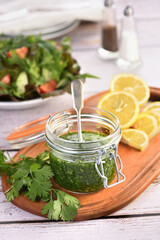 Green tasty herb sauce marinade from cilantro, parsley, oil, traditional seasoning for salad dressing