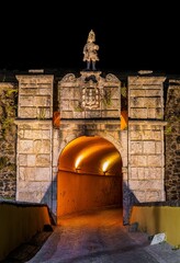 Vertical shot of an illuminated stone tower and tunnel in Elvas, Alentejo, Portugal