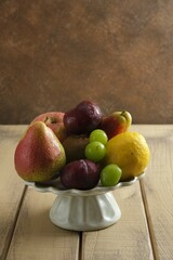 Fresh fruits on tier with brown background. Healthy food. Buah-buahan