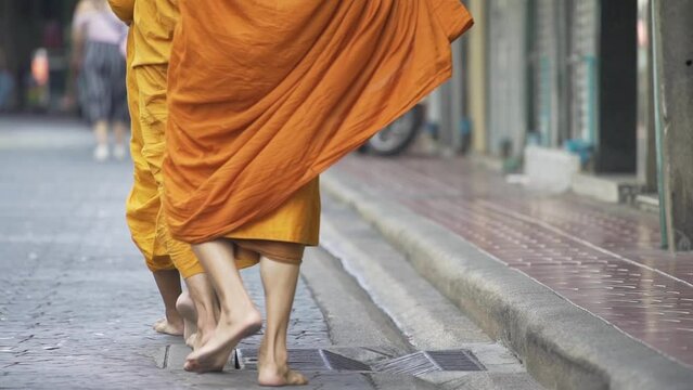 Behind the monks are walking around doing alms as per their morning duties.