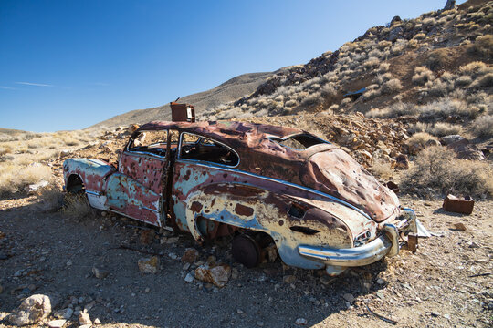 Old rusted out car in the desert