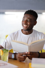 Happy young student in a library, surrounded by books, exuding confidence and representing the joy of education.