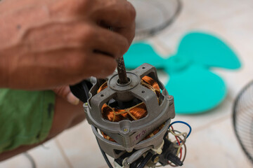 A man checks the rotor shaft for any rotating issues. Fixing a stuck rod. Cleaning and repairing an...