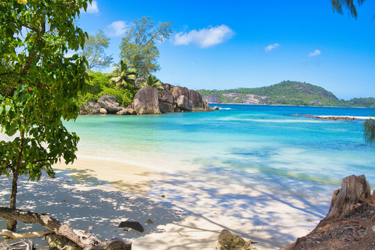 Sunny, white sandy beach, turquoise water at port glaud beach, Mahe, Seychelles