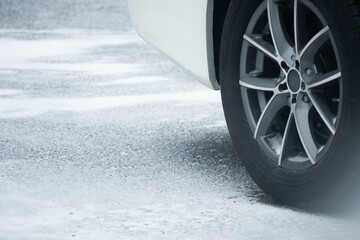car wheel on snowy pavement