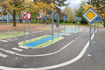 A children's playground designed as a mini road with road signs, providing an engaging environment for learning traffic rules and road safety skills through play. Prague, Europe