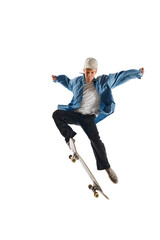 Sportive, active young man in casual clothes in motion, training with skateboard, doing stunts...