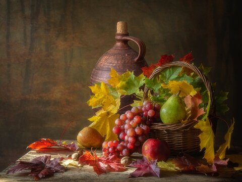 Autumn still life with fruits and falling leaves