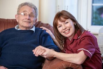 Help the Aged: Home Care. A visiting healthcare professional taking a moment with her senior patient. From a series of related images.