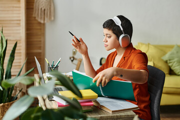 attractive hard working student with short hair and headphones studying hard at home, education