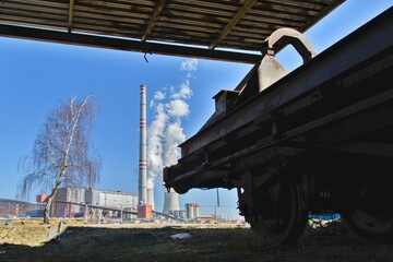 A thermal power plant and a tree in the foreground.