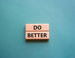 Do better symbol. Wooden blocks with words Do better. Beautiful grey green background. Business and Do better concept. Copy space.