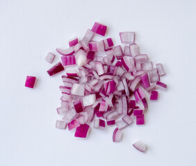 Red or purple onion chopped into small pieces in stack or pile isolated on white background. Red...
