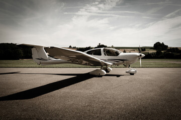small propeller aircraft parked at rural airport - obrazy, fototapety, plakaty