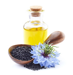 Black cumin oil with seeds on white background
