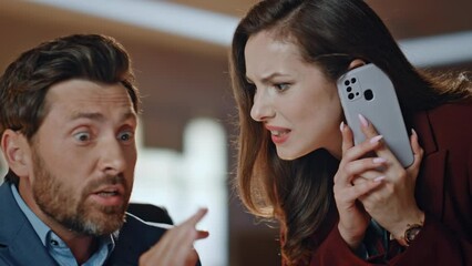 Closeup stressed business couple discussing cabinet. Angry director explaining