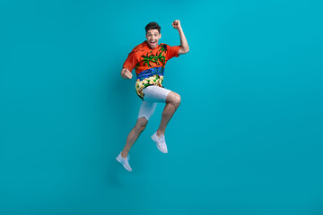 Fototapeta na wymiar Full body photo template banner advertisement funky guy jump fists up playing volleyball summer holidays isolated on blue color background