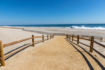 Beautiful view of the entrance of the ocean with the wooden fence in Pint Pleasant Beach, New Jersey