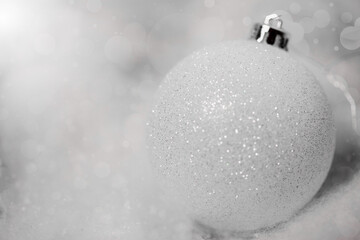 Magical christmas background. White globe in the snow.