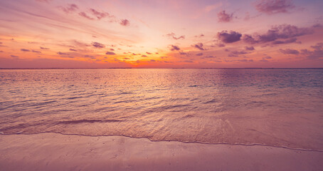 Fototapeta premium Closeup sea waves beach horizon. Panoramic beach landscape. Paradise tropical beach summer seascape. Colorful sunset sky, soft sand, calmness, tranquil relaxing sunlight. Inspire meditation vacation