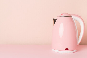 Modern electric pink kettle on color background