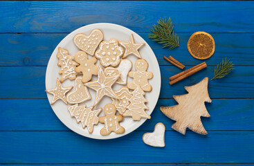 Cute homemade Christmas cookies with decor on wooden background,top view