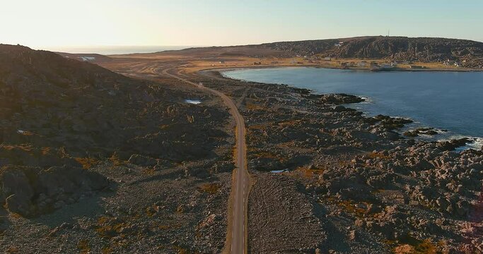 Aerial view of coast road 8100 an the town of Hamningberg in sunny summer weather, Varanger Peninsula, Norway.