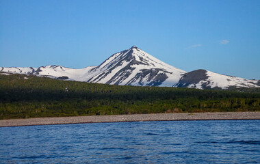 Fototapeta premium Peninsula Kamchatka Landscape. Small Snowy Mountains and Hills