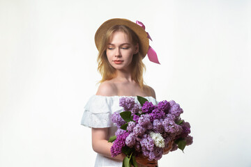 A young, beautiful girl with a large bouquet of lilacs. Vintage style.