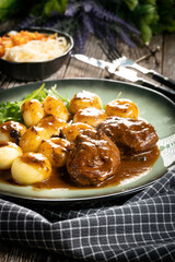 Traditional German braised pork cheeks in brown sauce.