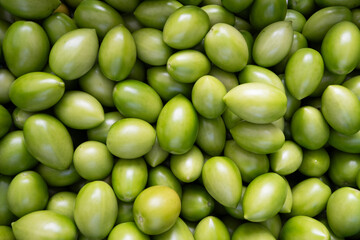 detail of ripe green tomatoes. Texture of many tomatoes harvested at the market