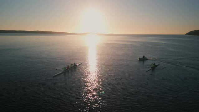 Cinematic Shot Drone seascape Rowing Sport Boats Calm Ocean Water With Sunrise