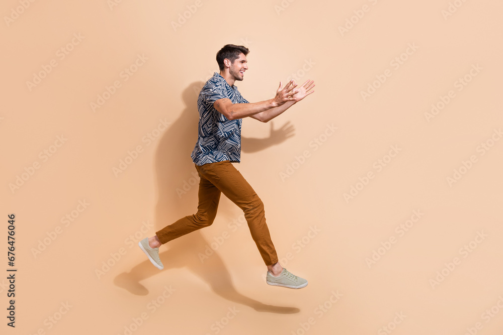 Poster Full body photo of energetic person jump over floor trying to catch discount promo code in empty space isolated on beige color background