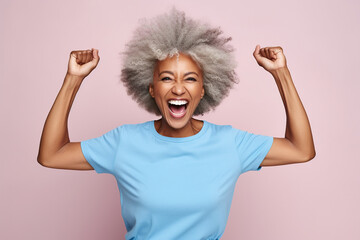 Elderly overjoyed excited fun cool African American woman 50s years old she wears blue undershirt casual clothes look camera spread hands isolated on plain pastel light pink background studio  - obrazy, fototapety, plakaty