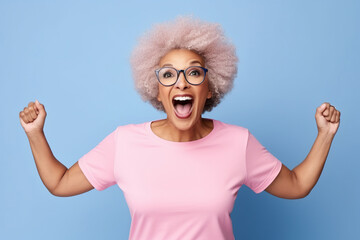 Elderly overjoyed excited fun cool African American woman 50s years old she wears pink undershirt casual clothes look camera spread hands isolated on plain pastel light blue background studio