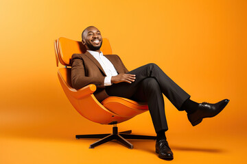 Fototapeta na wymiar Full length body cadre of satisfied African American businessman sitting psychotherapist session comfortable armchair isolated on orange color background