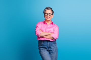 Portrait of good mood person with grey hairdo wear stylish blouse in eyewear holding hands crossed...