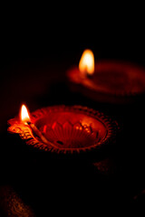 Lowkey Photograph of Diya in Diwali, Hindu festival of lights celebration. Diya oil lamp against dark background Low Key Photo, 9:16 Ratio good for mobile wallpaper High qaulity. Main Diya In focus 