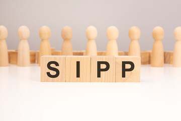 sipp - text composed from wooden blocks letters on white background, copy space for text