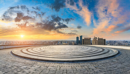 round city square and city skyline with sky clouds at sunset panoramic view - obrazy, fototapety, plakaty