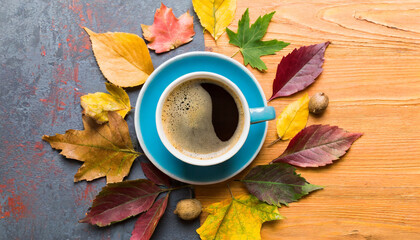 flat lay composition with colorful autumn cup of coffee and leaves on a color background top view