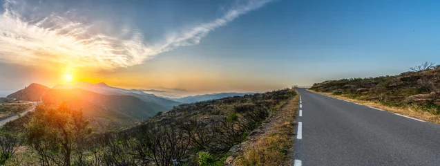 Fototapeten Mediterranean sea coast road into mountains horizon in summer with beautiful bright sun rays © AA+W