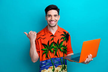 Photo of optimistic man wear orange shirt pointing finger mockup user laptop device taiwan beach...