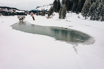 A frozen mountain lake with a dam for water energy