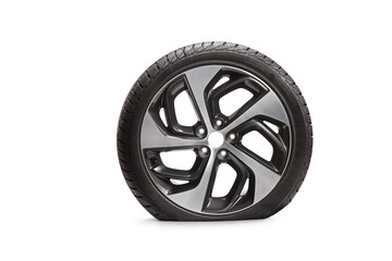 Studio shot of a flat vehicle tire with a rim