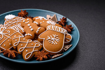 Beautiful Christmas gingerbread cookies of different colors on a ceramic plate