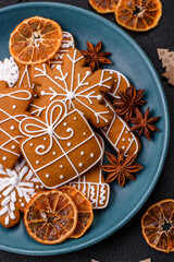 Beautiful Christmas gingerbread cookies of different colors on a ceramic plate