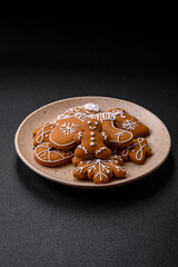Beautiful Christmas gingerbread cookies of different colors on a ceramic plate