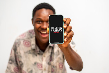 Portrait of Man hand holding smartphone with Black friday sale on the screen.