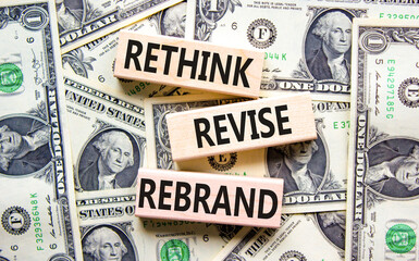 Rethink revise rebrand symbol. Concept word Rethink Revise Rebrand on block. Dollar bills. Beautiful dollar bills background. Business brand motivational rethink revise rebrand concept. Copy space.